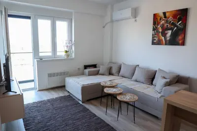 a living room with a couch and two tables at Vamos a la playa in Jagodina