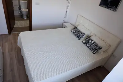 a bed with two pillows on it in a room at Vamos a la playa in Jagodina