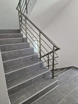 a staircase with metal railings and a tile floor at Apartman Nisić in Soko Banja