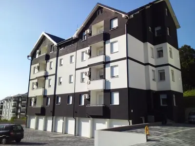 a building with a black and white facade at Apartman Nisić in Soko Banja