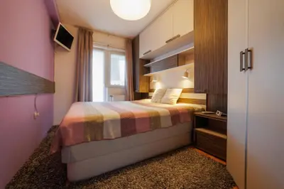 a small bedroom with a bed and a window at Lux 010 in Pirot