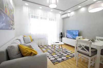 a living room with a couch and a table and a desk at Vrnjačka oaza in Vrnjačka Banja