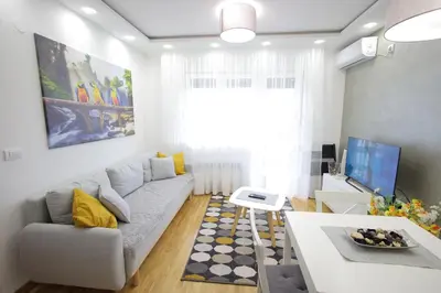 a living room with a couch and a table at Vrnjačka oaza in Vrnjačka Banja