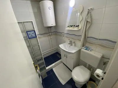 a small bathroom with a toilet and a sink at Apartman Lea in Paraćin