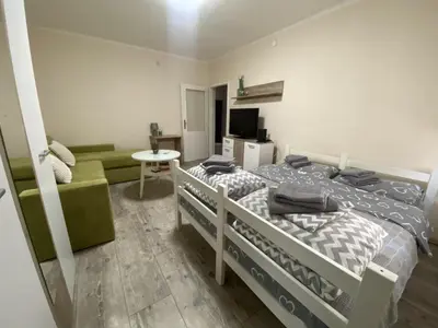 a bedroom with two bunk beds and a couch at Apartman Lea in Paraćin