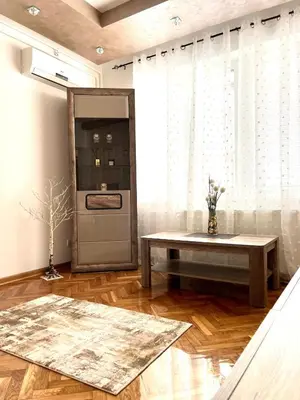 a living room with a table in front of a window at Lumo in Niš