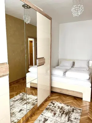 a bedroom with a mirror and a bed at Lumo in Niš