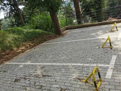 a brick road with yellow barricades on it at Centar Park Lux in Vrnjačka Banja