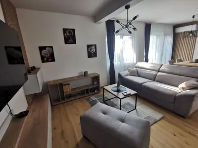 a living room with a couch and a table at Centar Park Lux in Vrnjačka Banja