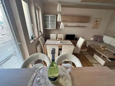 a dining room with a bottle of wine on a table at Pahira Lux in Paraćin