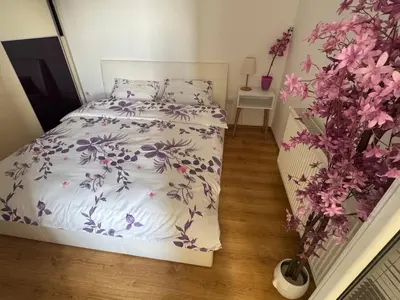 a bedroom with a bed with purple flowers on it at Pahira Lux in Paraćin