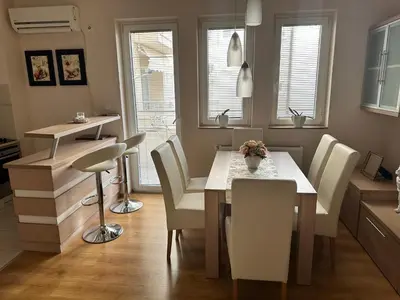 a kitchen and dining room with a table and chairs at Pahira Lux in Paraćin