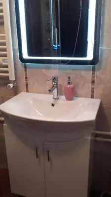 a bathroom sink with a mirror and a pink candle at Villa Snow Queen Kopaonik in Kopaonik