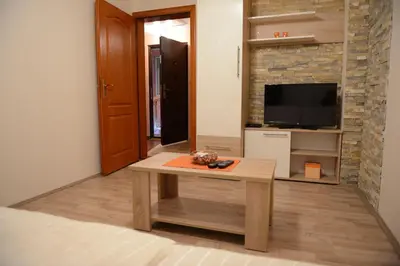 a living room with a coffee table and a tv at Villa Snow Queen Kopaonik in Kopaonik