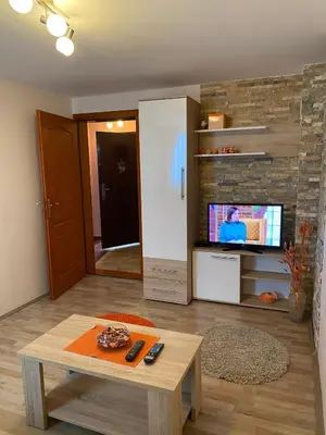 a living room with a coffee table and a tv at Villa Snow Queen Kopaonik in Kopaonik