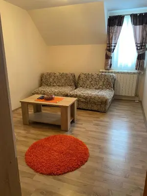 a living room with a couch and a coffee table at Villa Snow Queen Kopaonik in Kopaonik