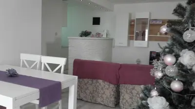 a living room with a christmas tree and a couch at Villa Snow Queen Kopaonik in Kopaonik