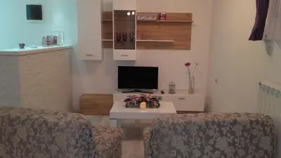 a living room with two chairs and a television at Villa Snow Queen Kopaonik in Kopaonik