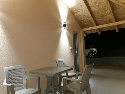 a table and chairs sitting on a patio at Porta Simića in Ribarska Banja