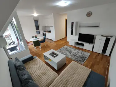 a living room with a couch and a table at Apartman Popovic in Soko Banja