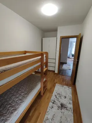 a bedroom with two bunk beds and a hallway at Apartman Popovic in Soko Banja