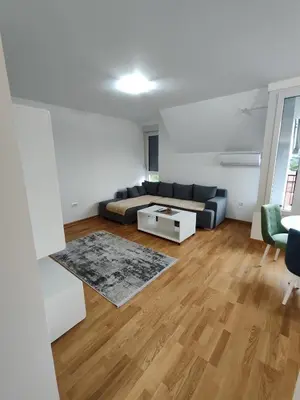 a living room with a couch and a table at Apartman Popovic in Soko Banja