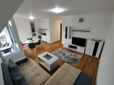 a living room with a couch and a table at Apartman Popovic in Soko Banja