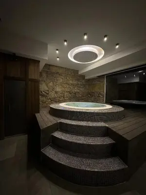 a bathroom with a hot tub and stairs in it at Vila Golija Peak Suites in Kopaonik