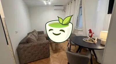 a living room with a couch and an apple painted on the wall at Petra Apartments in Jagodina