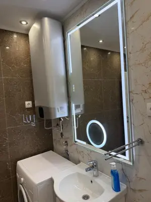 a bathroom with a sink and a mirror at Petra Apartments in Jagodina