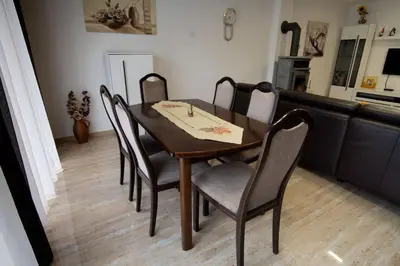 a dining room with a table and chairs at Raj Petrović in Kovanluk