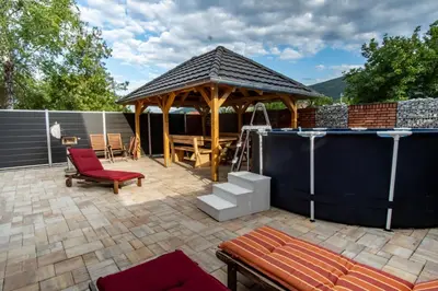 a patio with a gazebo and a table and chairs at Raj Petrović in Kovanluk