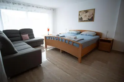 a bedroom with a bed and a couch at Raj Petrović in Kovanluk
