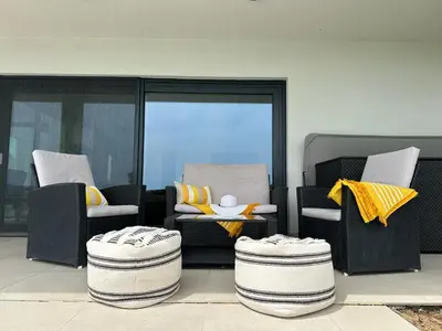 a patio with two chairs and a table with yellow pillows at Hacienda R - kuca sa bazenom in Siokovac