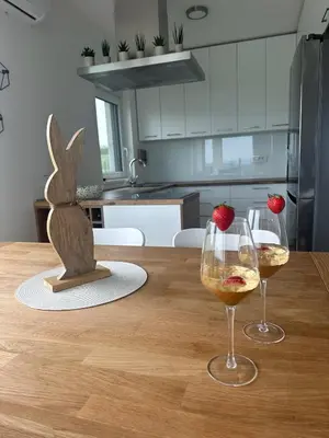 a table with two glasses of wine and a bunny statue at Hacienda R - kuca sa bazenom in Siokovac