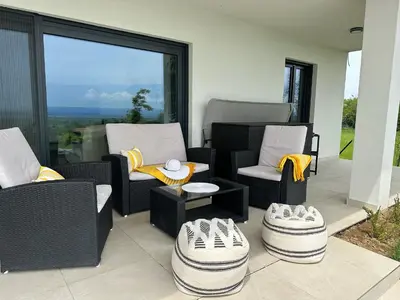 a patio with two chairs and a table with shoes on it at Hacienda R - kuca sa bazenom in Siokovac