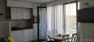 a kitchen with a table and chairs and a window at CENTAR CEPERKOVIC in Vrnjačka Banja