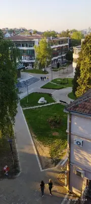 a group of people walking down a street in a city at CENTAR CEPERKOVIC in Vrnjačka Banja
