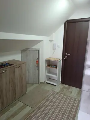 an empty kitchen with a door and a cabinet at Apartman SJAJ in Soko Banja