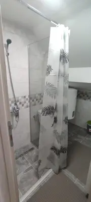 a bathroom with a shower with a shower curtain at Apartman SJAJ in Soko Banja