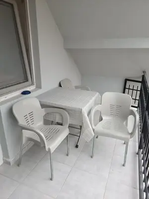 a table and two chairs and a table and chairs at Apartman SJAJ in Soko Banja