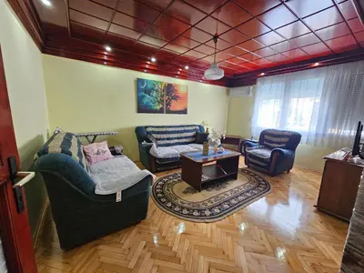 a living room with two couches and a table at Apartman Purić in Pirot