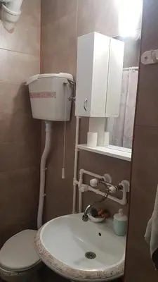 a bathroom with a white sink and a toilet at Apartman Purić in Pirot