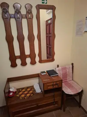 a dressing table with a mirror and a chair at Apartman Purić in Pirot