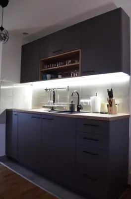a kitchen with black cabinets and a sink at Penthaus apartman NOVAK in Vrnjci