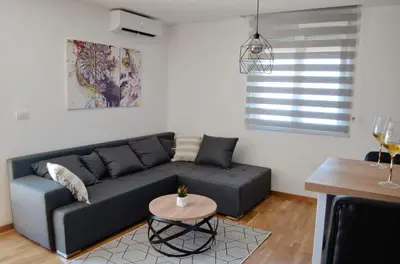 a living room with a couch and a table at Penthaus apartman NOVAK in Vrnjci