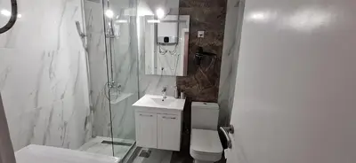 a bathroom with a shower and a sink and a toilet at Symphony in Pirot