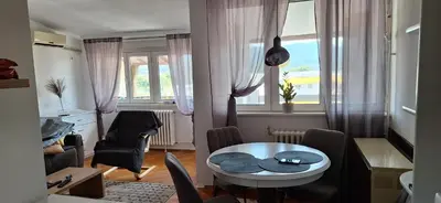 a small living room with a table and chairs at Symphony in Pirot