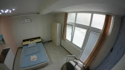 a small room with a bed and a window at Cozy Quiet Apartment Nis in Niš