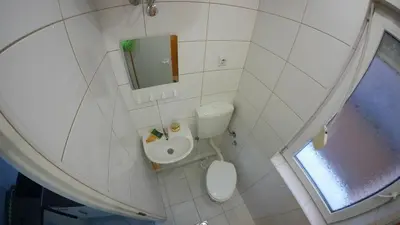 a small bathroom with a toilet and a sink at Cozy Quiet Apartment Nis in Niš